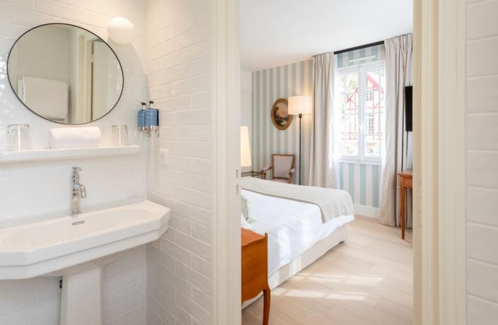 salle de bain blanche avec chambre adjacente - hotel 4 etoiles la baule